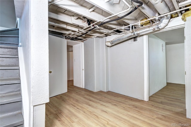 3336 N Saint Paul St, Denver, CO 80205 - unfinished basement with wood finished floors and stairway
