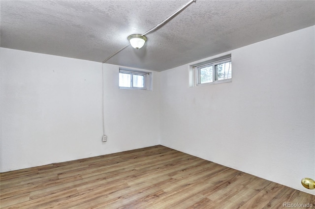 3336 N Saint Paul St, Denver, CO 80205 - below grade area featuring a textured ceiling and light wood finished floors