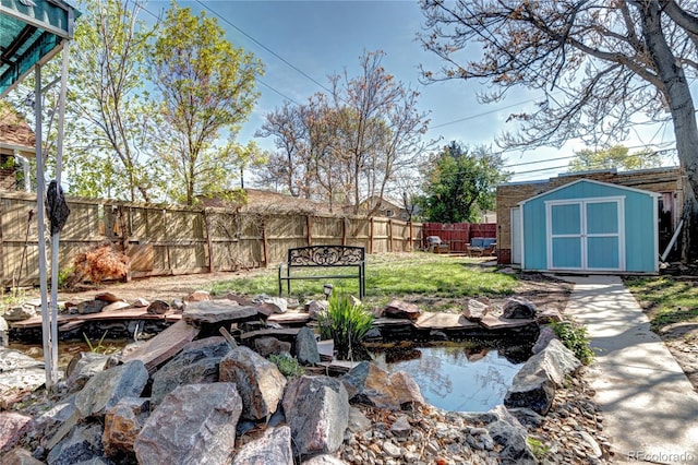 3336 N Saint Paul St, Denver, CO 80205 - view of yard featuring a storage shed, a garden pond, an outdoor structure, and fence