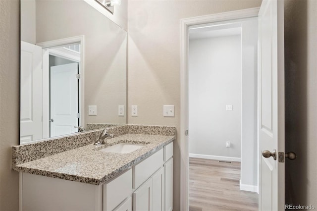 bathroom featuring hardwood / wood-style floors and vanity