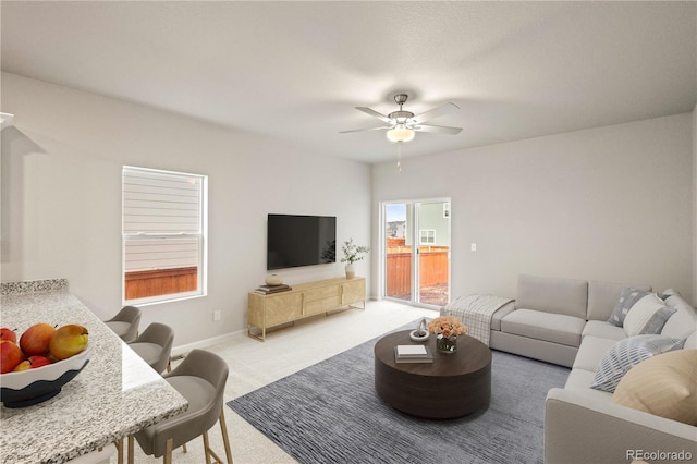 living room with carpet flooring and ceiling fan