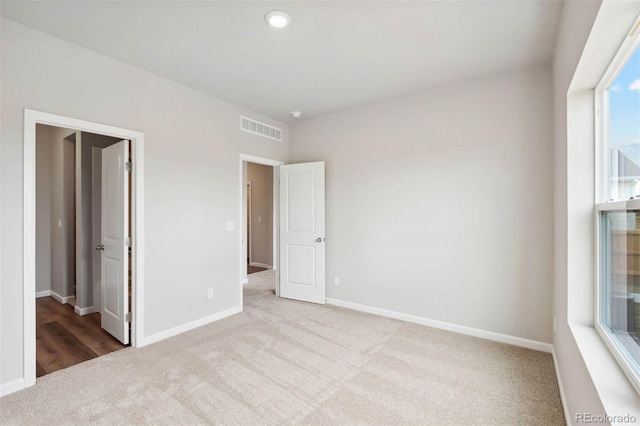 unfurnished bedroom featuring light colored carpet