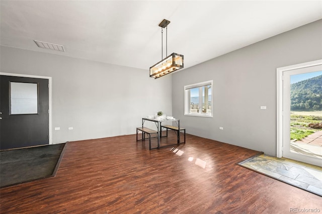 224 Lakeview Forest Hts, Florissant, CO 80816 - spare room featuring wood finished floors and a chandelier