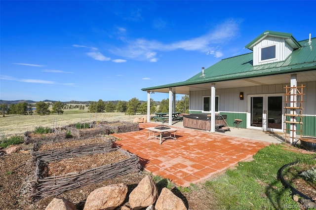 224 Lakeview Forest Hts, Florissant, CO 80816 - view of patio with a hot tub, french doors, a fire pit, and a mountain view