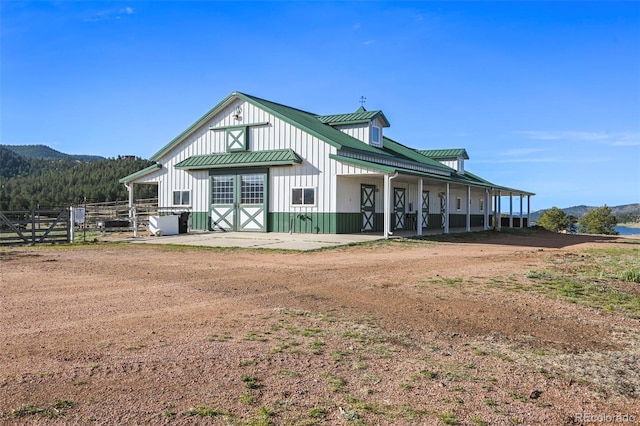 224 Lakeview Forest Hts, Florissant, CO 80816 - view of front of house with board and batten siding, metal roof, a standing seam roof, and a mountain view