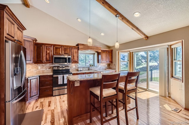 kitchen with light wood-type flooring, lofted ceiling with beams, backsplash, and appliances with stainless steel finishes