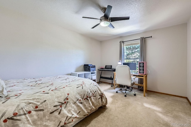 carpeted bedroom featuring a textured ceiling, baseboards, and a ceiling fan