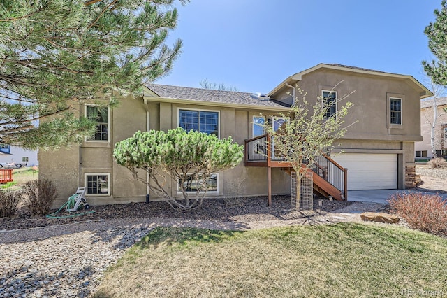 view of front of home with concrete driveway, stairway, stucco siding, and an attached garage