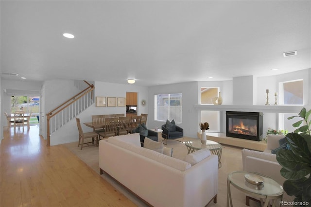 21229 E 50th Ave, Denver, CO 80249 - living area featuring stairway, a glass covered fireplace, visible vents, and recessed lighting