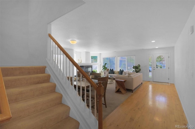 21229 E 50th Ave, Denver, CO 80249 - interior space with recessed lighting, light wood-style floors, a glass covered fireplace, and stairs