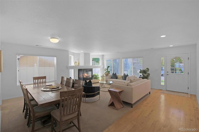 21229 E 50th Ave, Denver, CO 80249 - living room with recessed lighting, light wood-style floors, and a glass covered fireplace