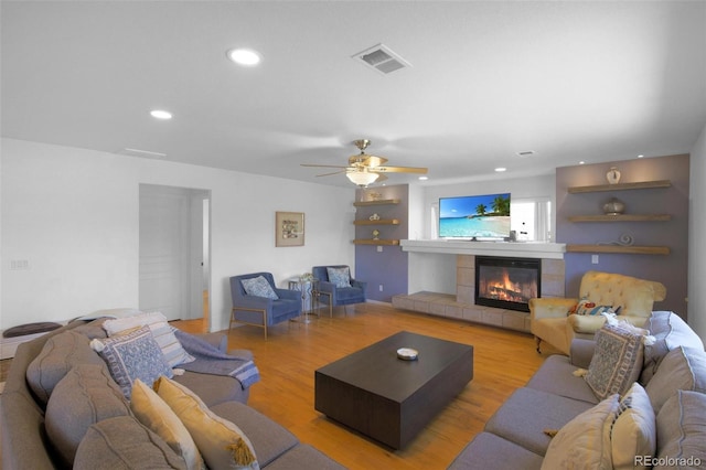21229 E 50th Ave, Denver, CO 80249 - living room featuring recessed lighting, a tile fireplace, visible vents, and light wood-style floors