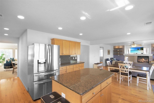 21229 E 50th Ave, Denver, CO 80249 - kitchen with visible vents, recessed lighting, light wood-style flooring, stainless steel fridge, and a kitchen island