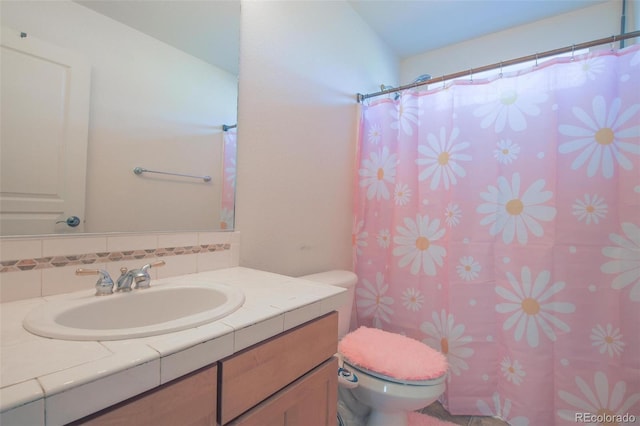 21229 E 50th Ave, Denver, CO 80249 - full bath with toilet, vanity, a shower with shower curtain, and tasteful backsplash