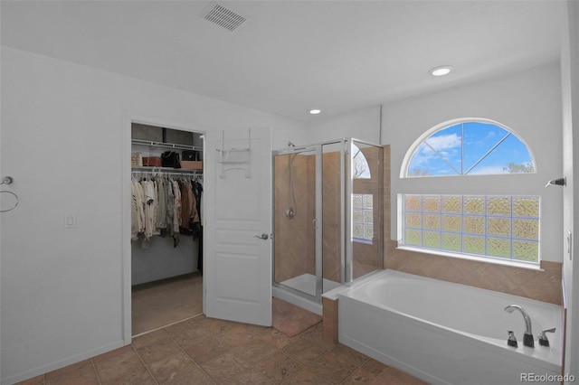 21229 E 50th Ave, Denver, CO 80249 - full bathroom featuring a stall shower, recessed lighting, visible vents, a bath, and a walk in closet