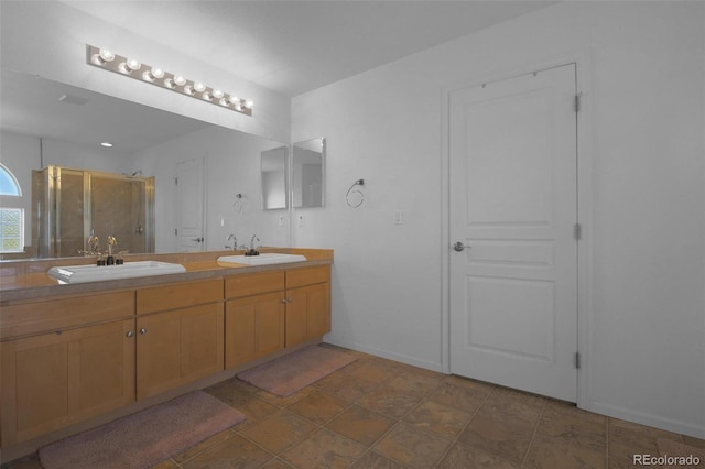 21229 E 50th Ave, Denver, CO 80249 - bathroom featuring double vanity, a shower stall, stone finish flooring, and a sink