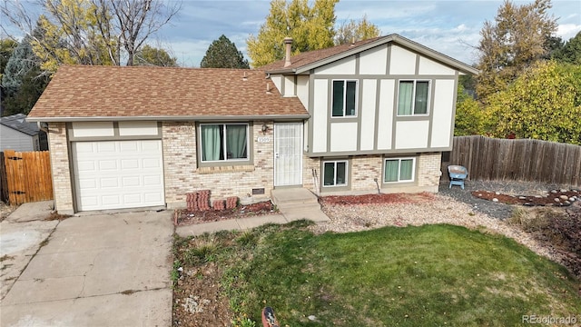 view of front of property featuring a shingled roof, an attached garage, fence, and brick siding