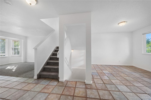 4064 S Himalaya Way, Aurora, CO 80013 - stairs featuring baseboards and stone finish floors