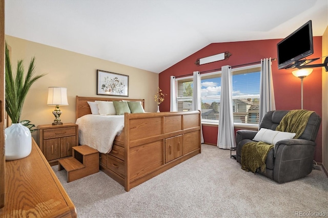 bedroom featuring vaulted ceiling and light colored carpet