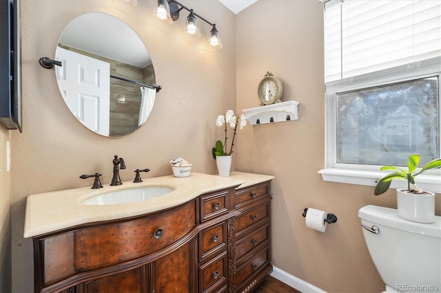 bathroom with vanity, baseboards, toilet, and a shower with shower curtain