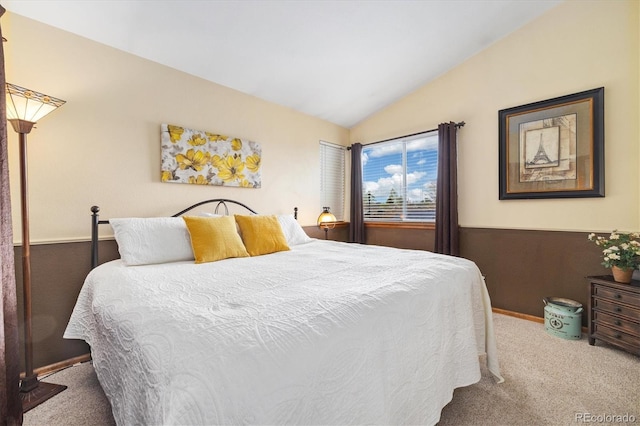 bedroom with baseboards, carpet, and lofted ceiling