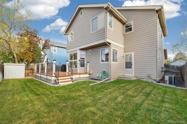 back of property featuring a fenced backyard, a yard, cooling unit, and a deck
