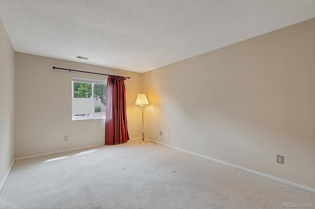 unfurnished room featuring a textured ceiling and carpet