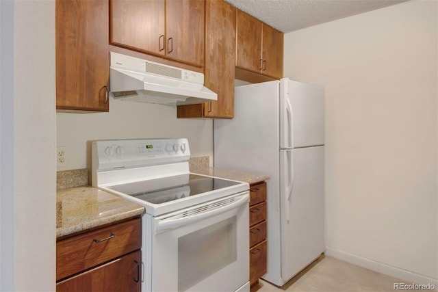 6505 Kalua Rd Unit 104B, Boulder, CO 80301 - kitchen featuring white appliances, under cabinet range hood, and brown cabinets