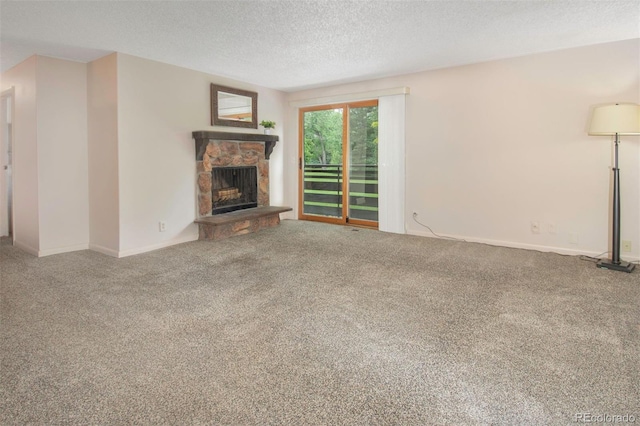 6505 Kalua Rd Unit 104B, Boulder, CO 80301 - unfurnished living room featuring a stone fireplace, a textured ceiling, and carpet