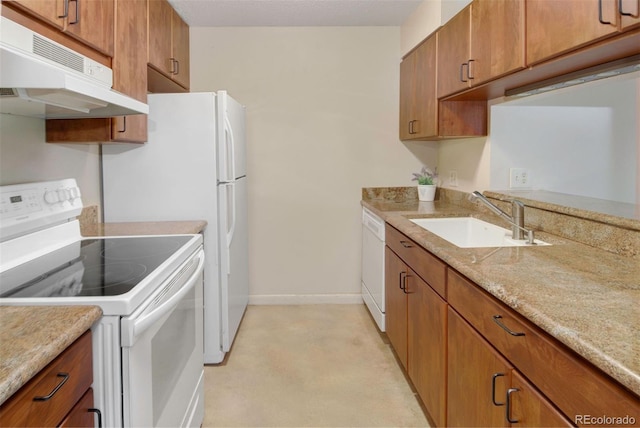 6505 Kalua Rd Unit 104B, Boulder, CO 80301 - kitchen with white appliances, under cabinet range hood, brown cabinetry, and light stone countertops