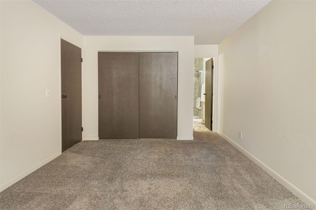 6505 Kalua Rd Unit 104B, Boulder, CO 80301 - unfurnished bedroom featuring carpet flooring, a closet, and a textured ceiling