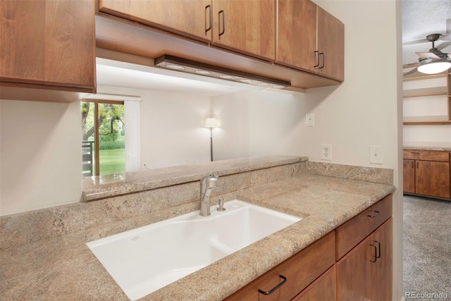 6505 Kalua Rd Unit 104B, Boulder, CO 80301 - kitchen featuring light stone counters, brown cabinets, and carpet