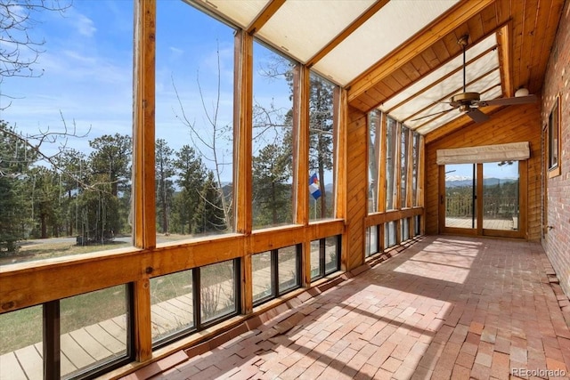 unfurnished sunroom with a ceiling fan