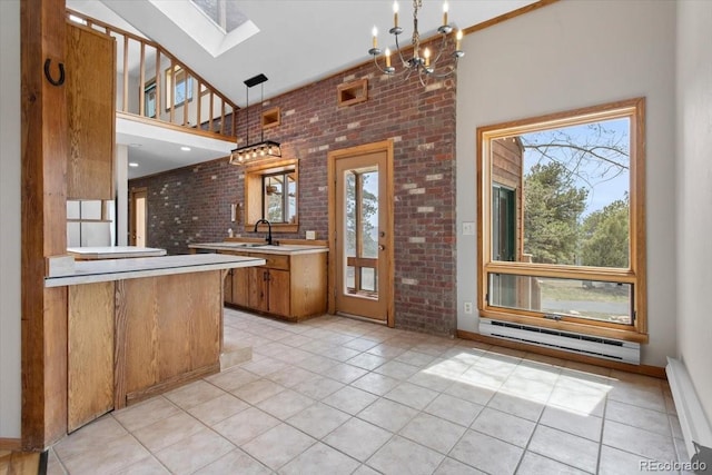 kitchen with a baseboard heating unit, a high ceiling, plenty of natural light, and a skylight