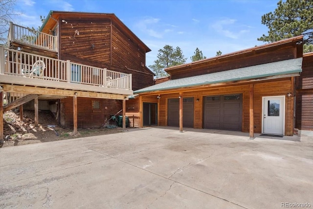exterior space featuring concrete driveway and an attached garage