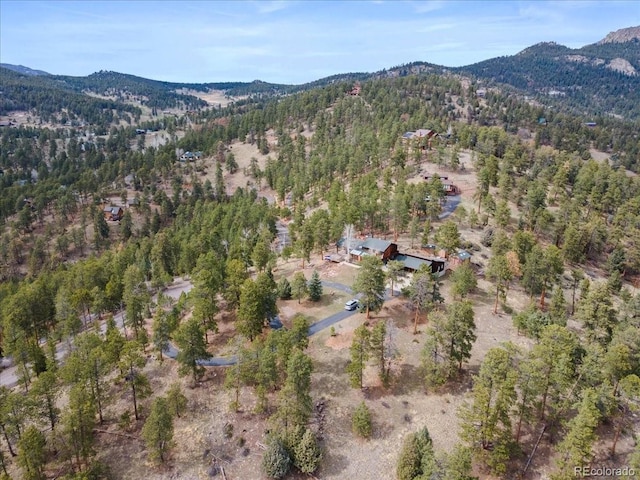 drone / aerial view featuring a mountain view and a forest view