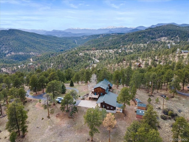 bird's eye view featuring a forest view and a mountain view