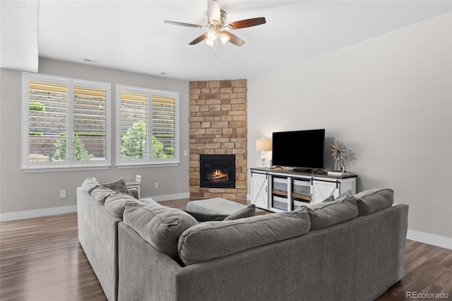 12214 Stone Timber Ct, Parker, CO 80134 - living area with a ceiling fan, baseboards, dark wood-type flooring, and a stone fireplace