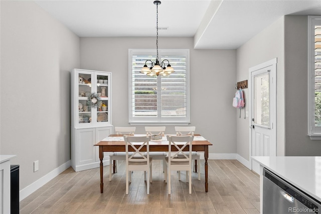 12214 Stone Timber Ct, Parker, CO 80134 - dining space featuring a chandelier, light wood-style flooring, and baseboards