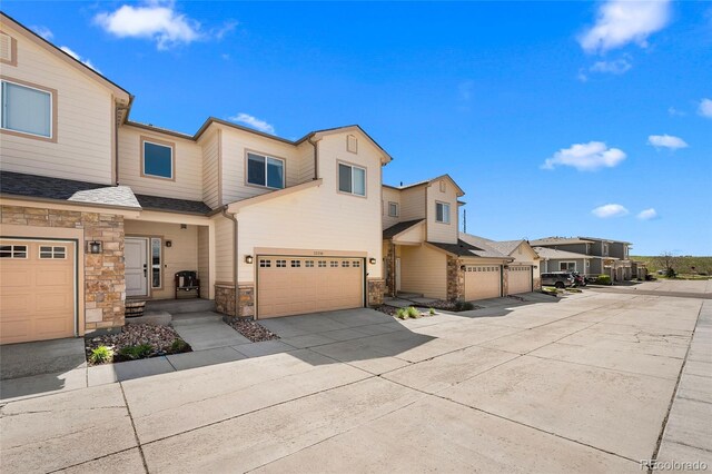 12214 Stone Timber Ct, Parker, CO 80134 - multi unit property with stone siding, concrete driveway, a garage, and a residential view
