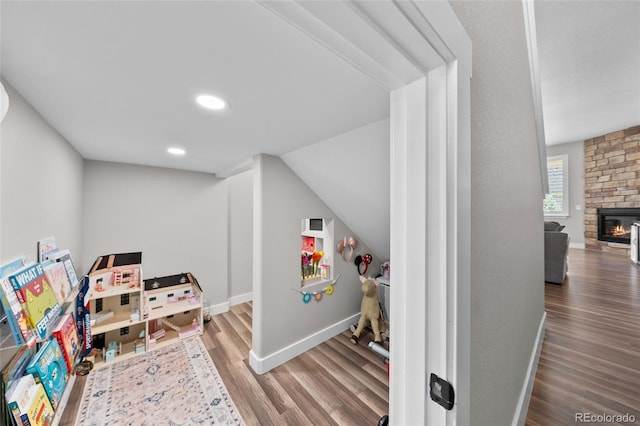12214 Stone Timber Ct, Parker, CO 80134 - playroom featuring wood finished floors, a fireplace, and recessed lighting
