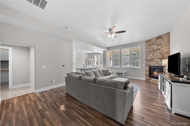 12214 Stone Timber Ct, Parker, CO 80134 - living room with ceiling fan, a fireplace, and dark wood-style flooring