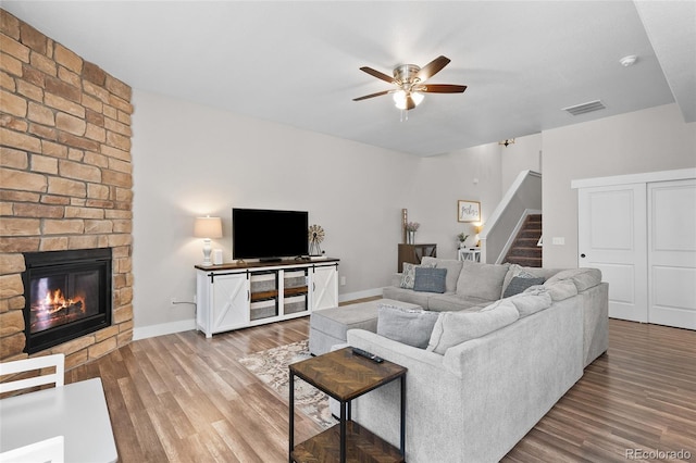 12214 Stone Timber Ct, Parker, CO 80134 - living room with ceiling fan, stairs, wood finished floors, and a fireplace