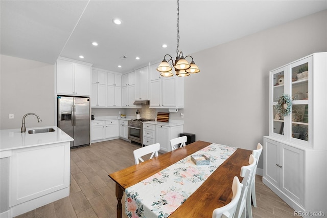 12214 Stone Timber Ct, Parker, CO 80134 - dining space featuring light wood-style flooring, a chandelier, and recessed lighting