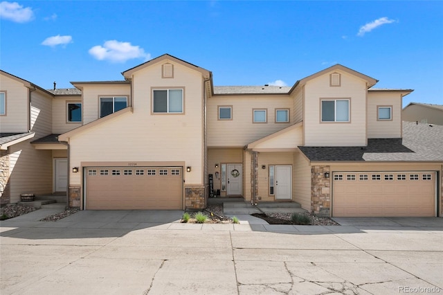 12214 Stone Timber Ct, Parker, CO 80134 - townhome / multi-family property featuring a garage, concrete driveway, and stone siding