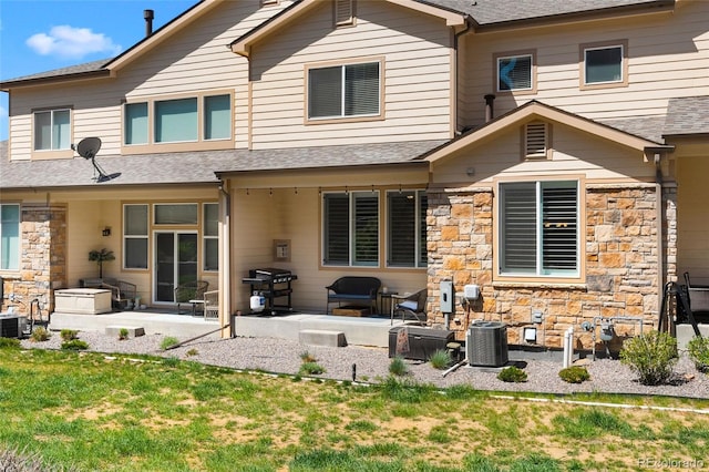 12214 Stone Timber Ct, Parker, CO 80134 - rear view of house featuring a patio, stone siding, a shingled roof, and a yard