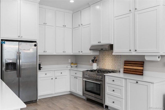 12214 Stone Timber Ct, Parker, CO 80134 - kitchen with stainless steel appliances, under cabinet range hood, light countertops, white cabinets, and recessed lighting