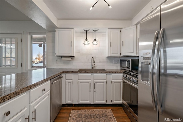 kitchen with white cabinetry, sink, stainless steel appliances, and dark hardwood / wood-style floors