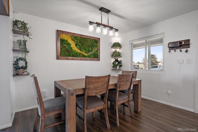 dining space with dark hardwood / wood-style flooring