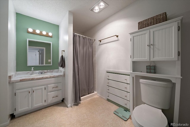 bathroom featuring toilet, vanity, a textured ceiling, and a shower with shower curtain